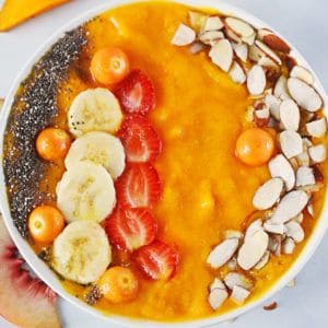 overhead shot of mango smoothie in a white bowl