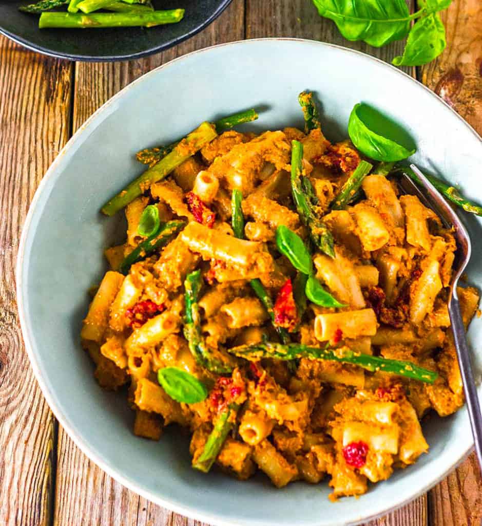 Sun-Dried Tomato Pesto Pasta on white bowl wooden background