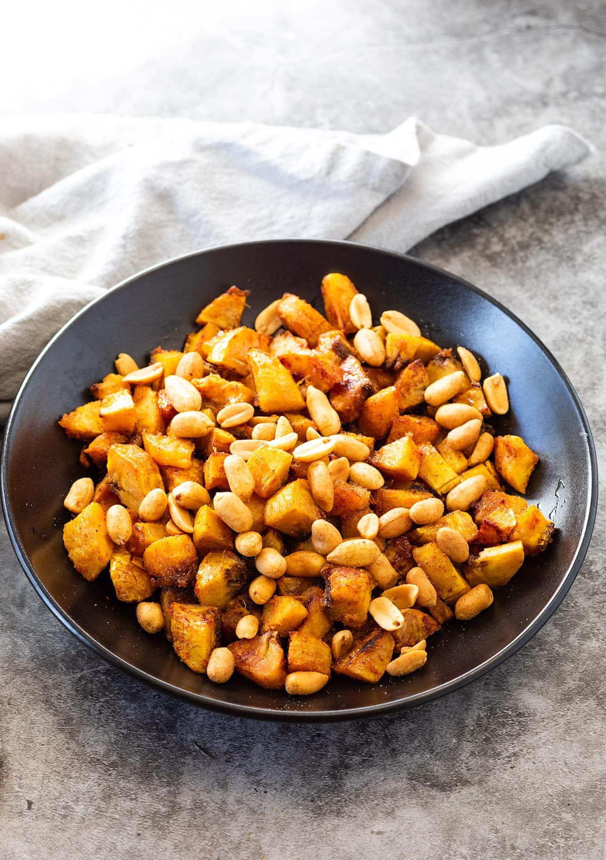 Baked Kelewele in a black bowl