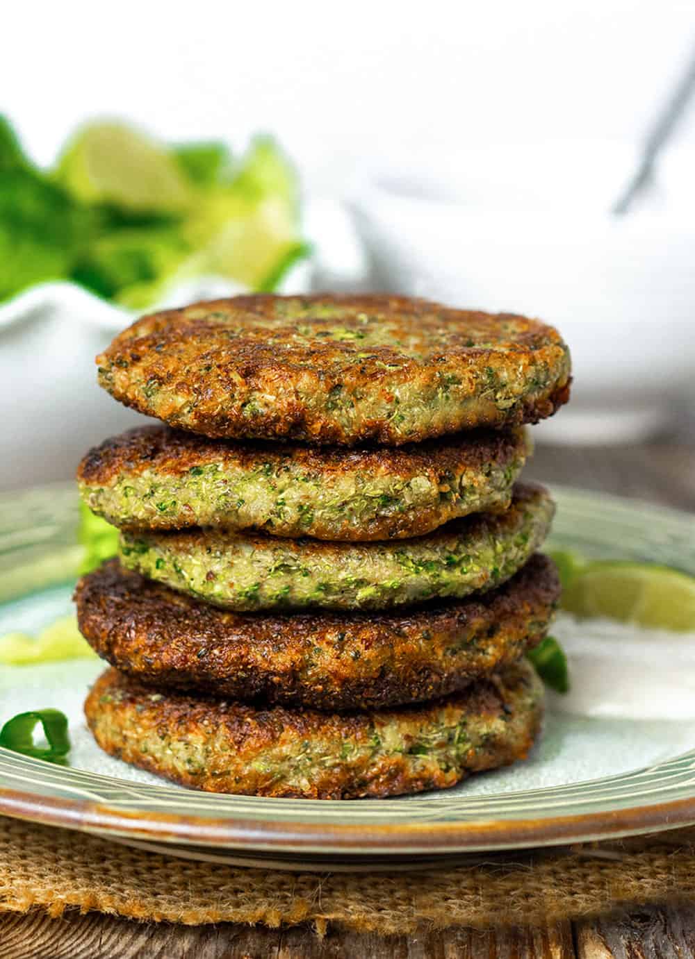 Broccoli Fritters stacked on a green plate on wooden background
