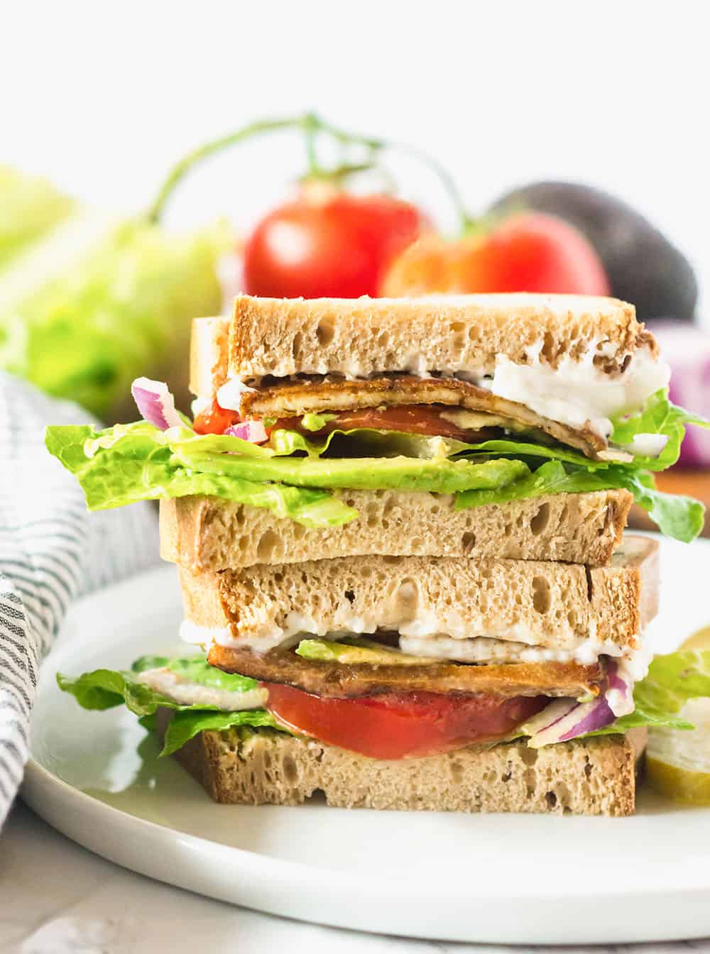 Vegan BLT Sandwich on white plate white background