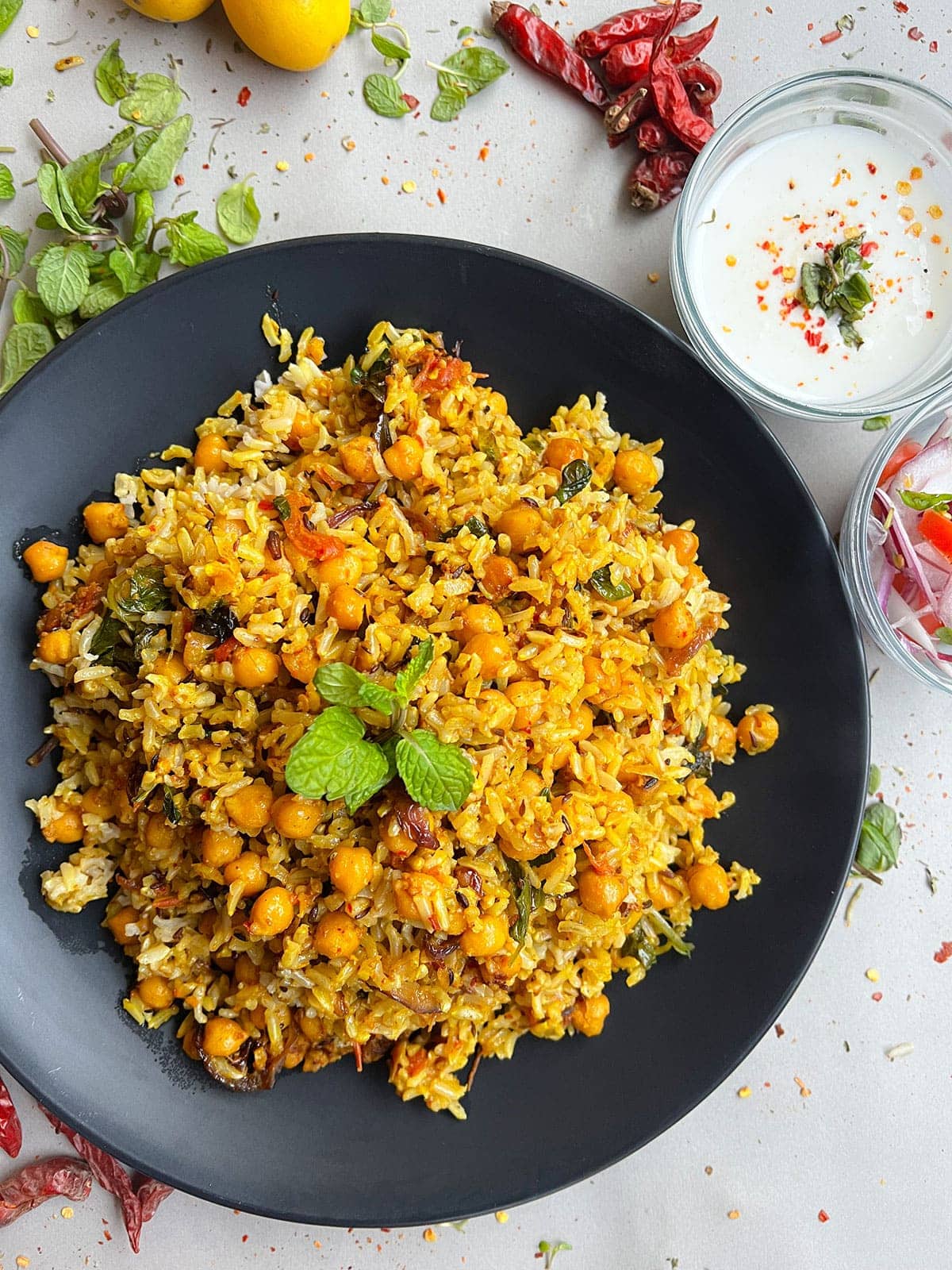 Brown Rice Chickpea Biryani in black bowl on white backgorund