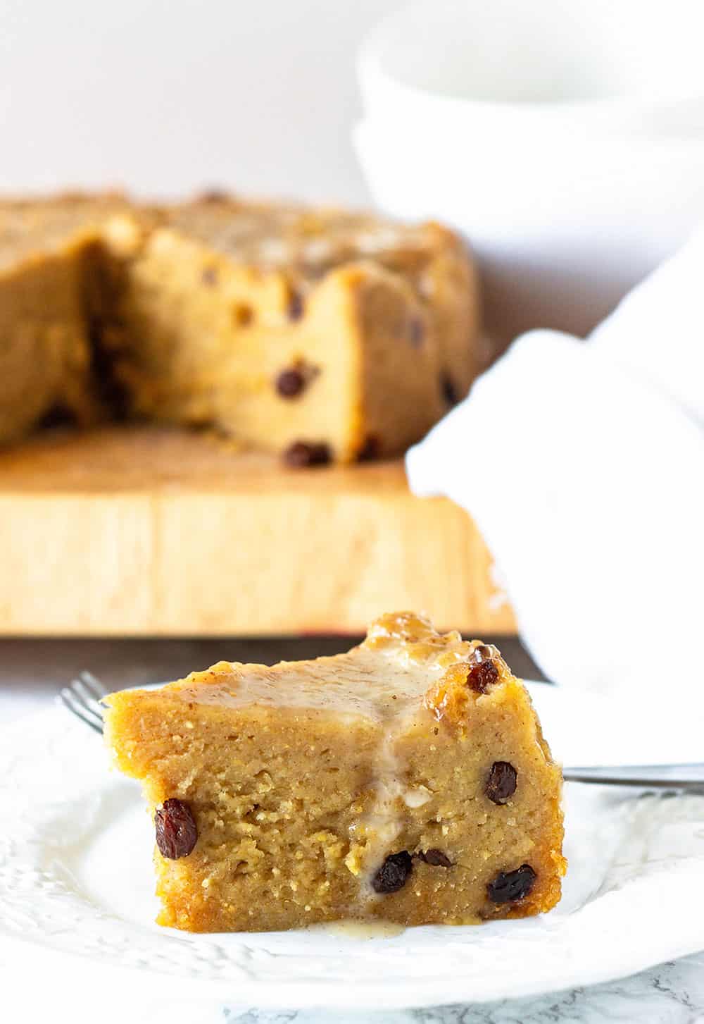 easy cornmeal pudding on white plate on white background