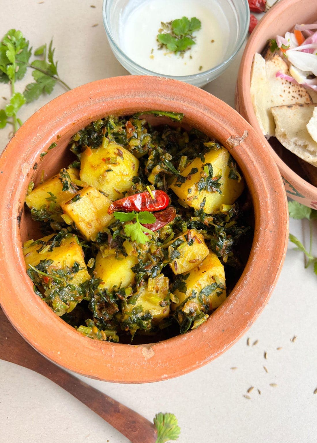 fenugreek and potatoes on a clay bowl on white background