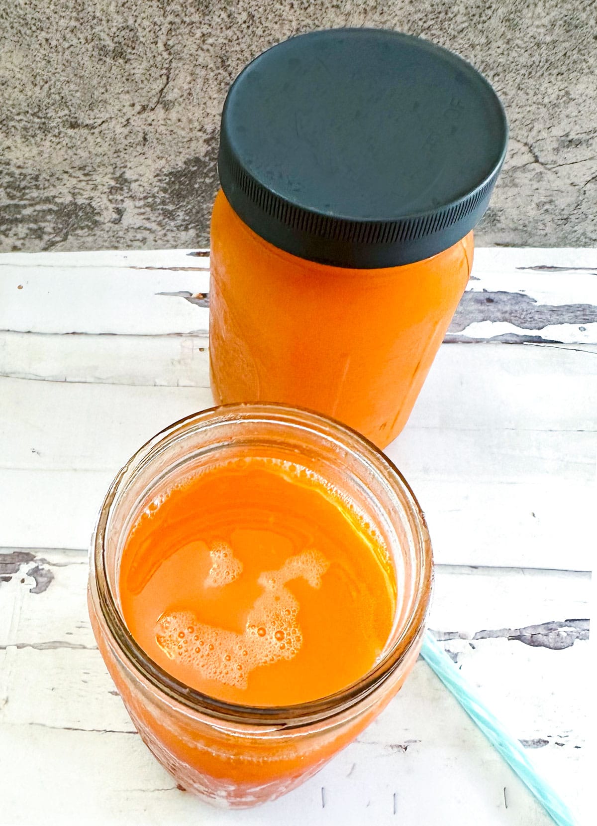 Glowing skin juice in two glass jars on white background