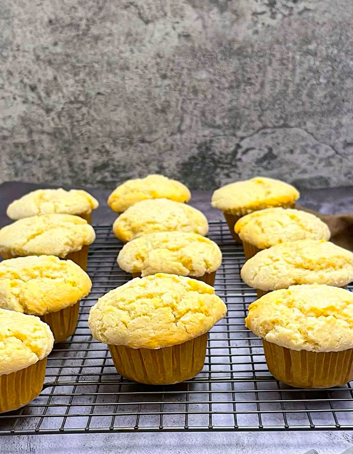 gluten free vegan corn muffins on cooking rack with a grey background
