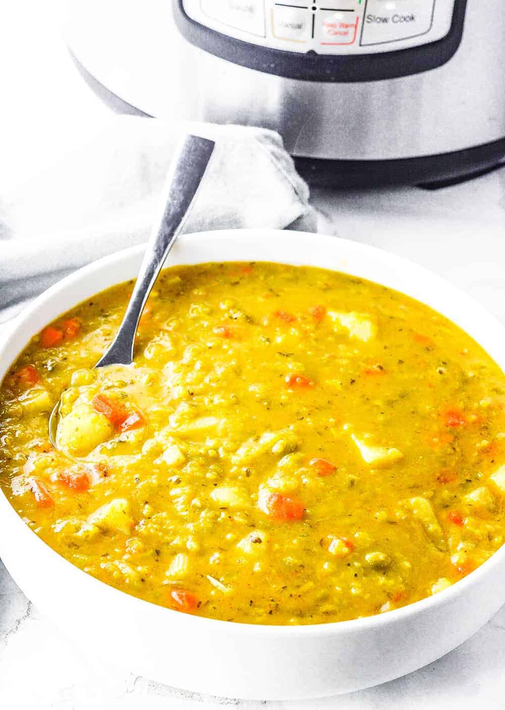 Split pea soup in a white bowl on white background