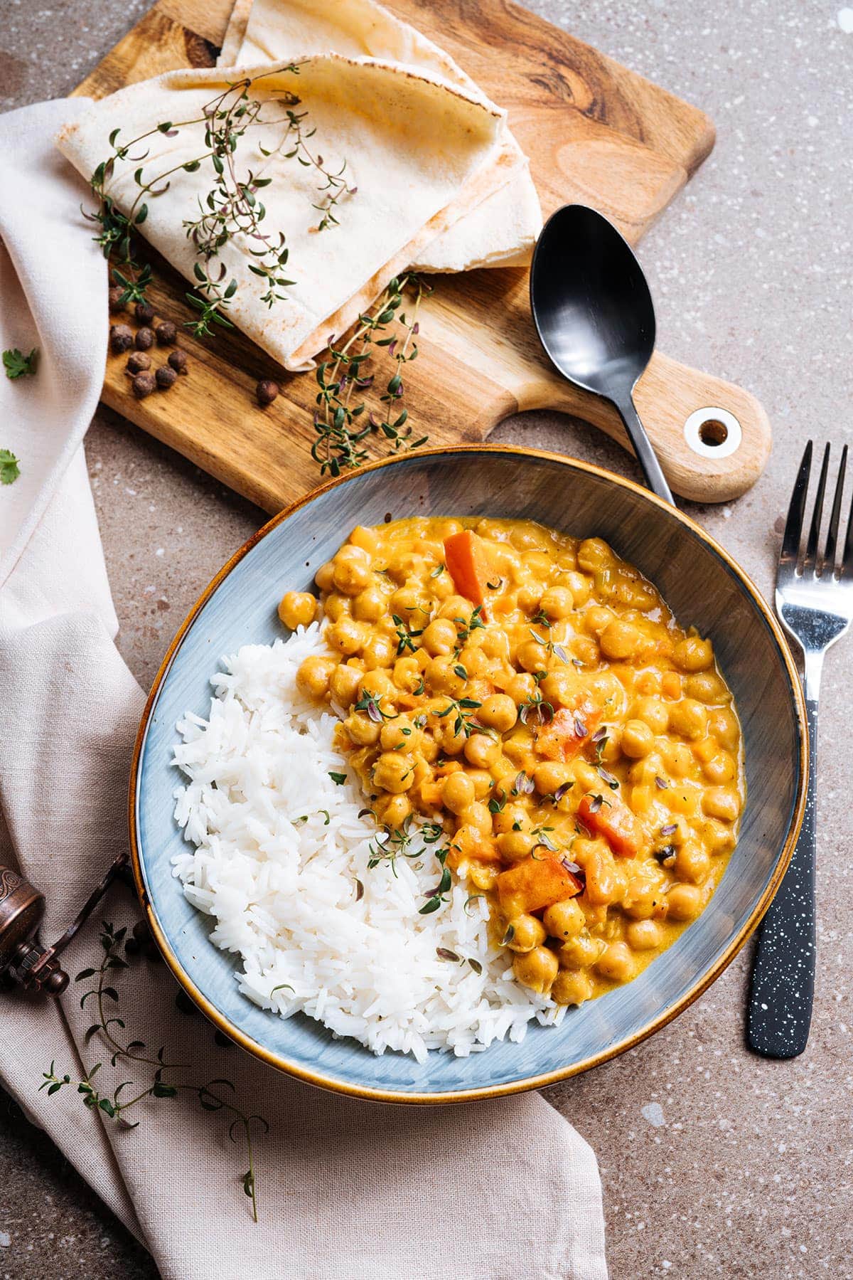 jamaican style chickpea curry on grey bowl on brown background