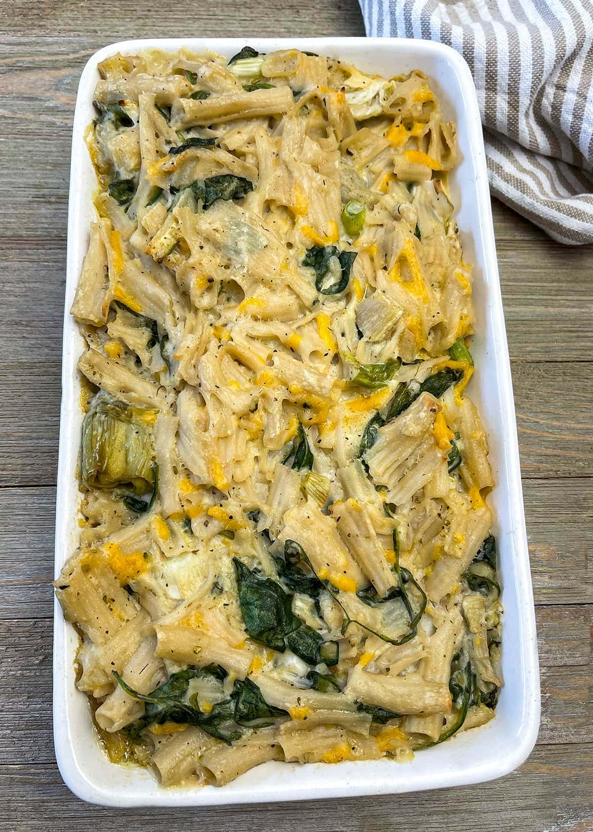 Spinach Artichoke Pasta Bake on a white casserole