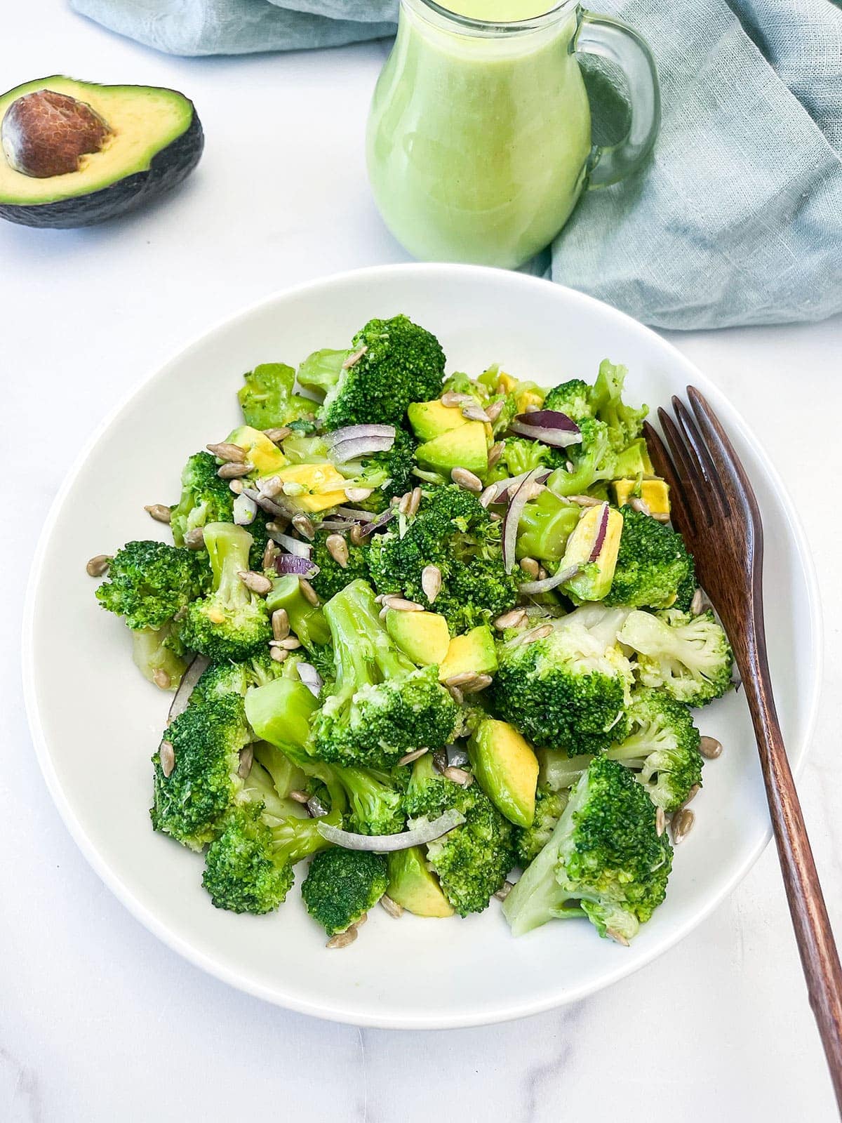 Vegan Broccoli Salad on a white plate on white background