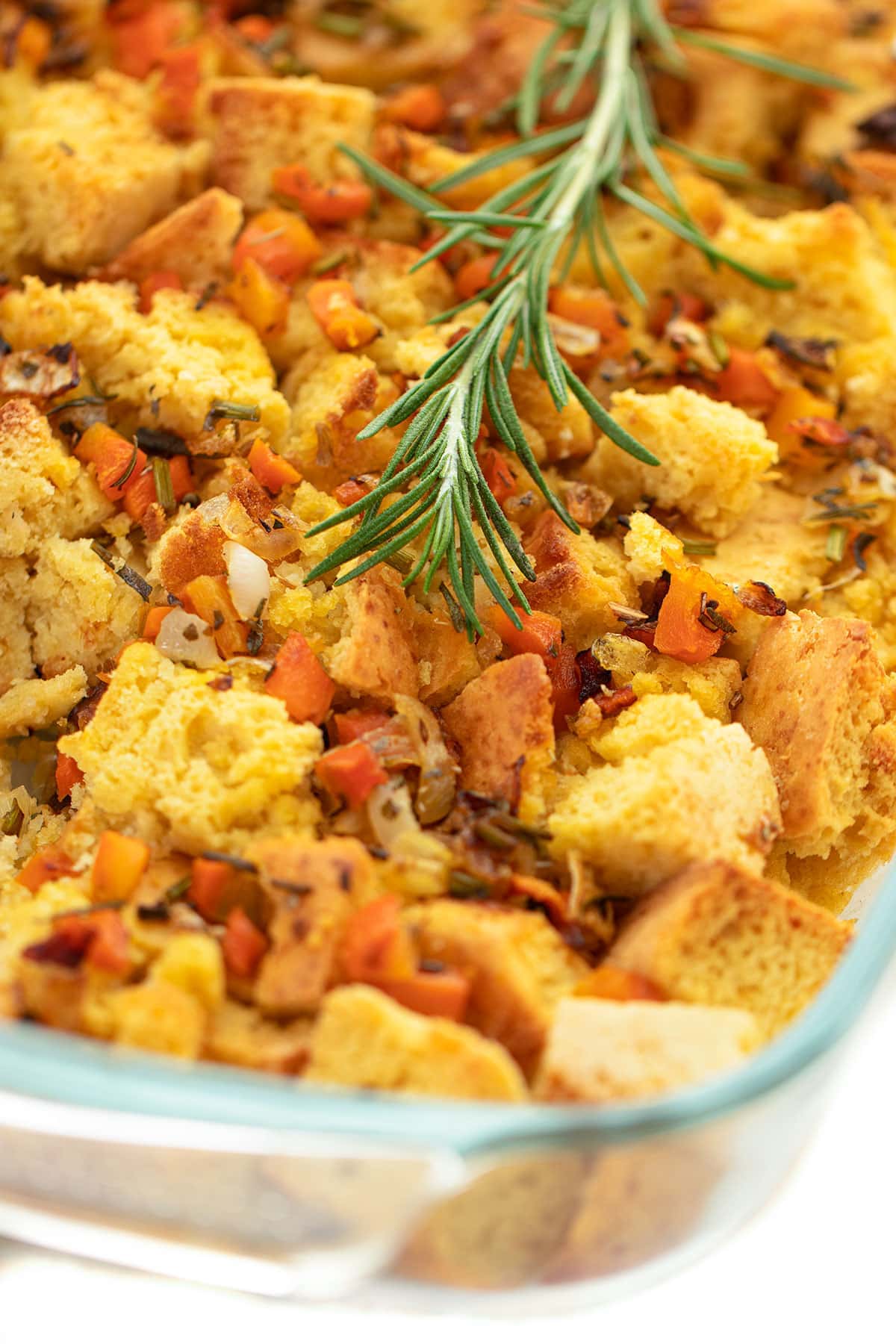 Vegan Cornbread Stuffing Recipe in glass caserole on white background