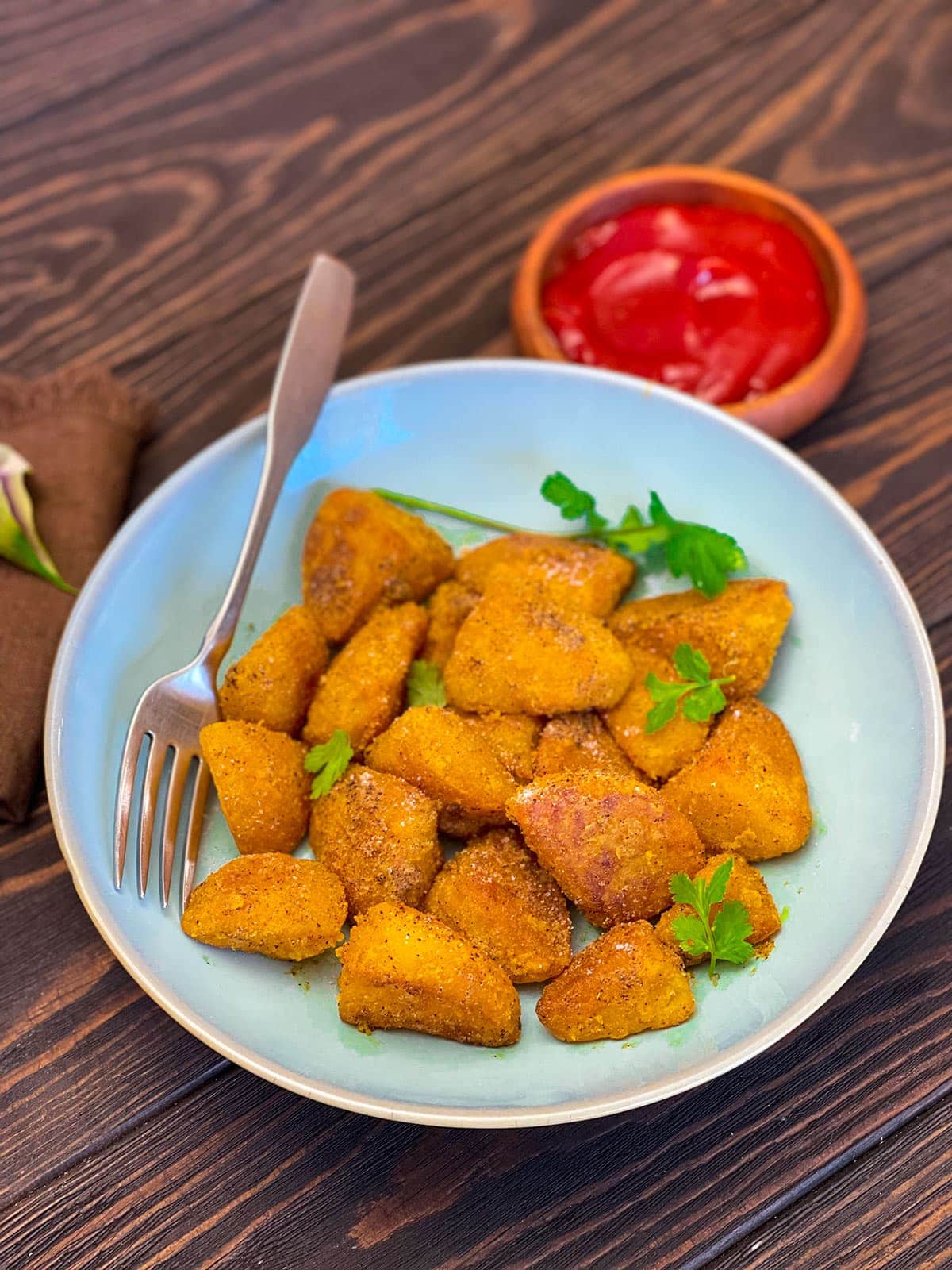 Viazi karai on a blue bowl on wooden background