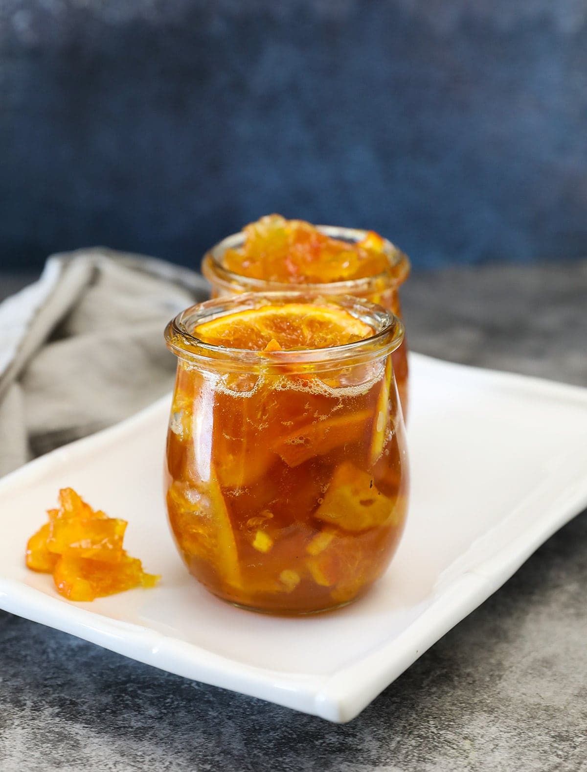 Watermelon Rind Preserves in a glass jar on grey background