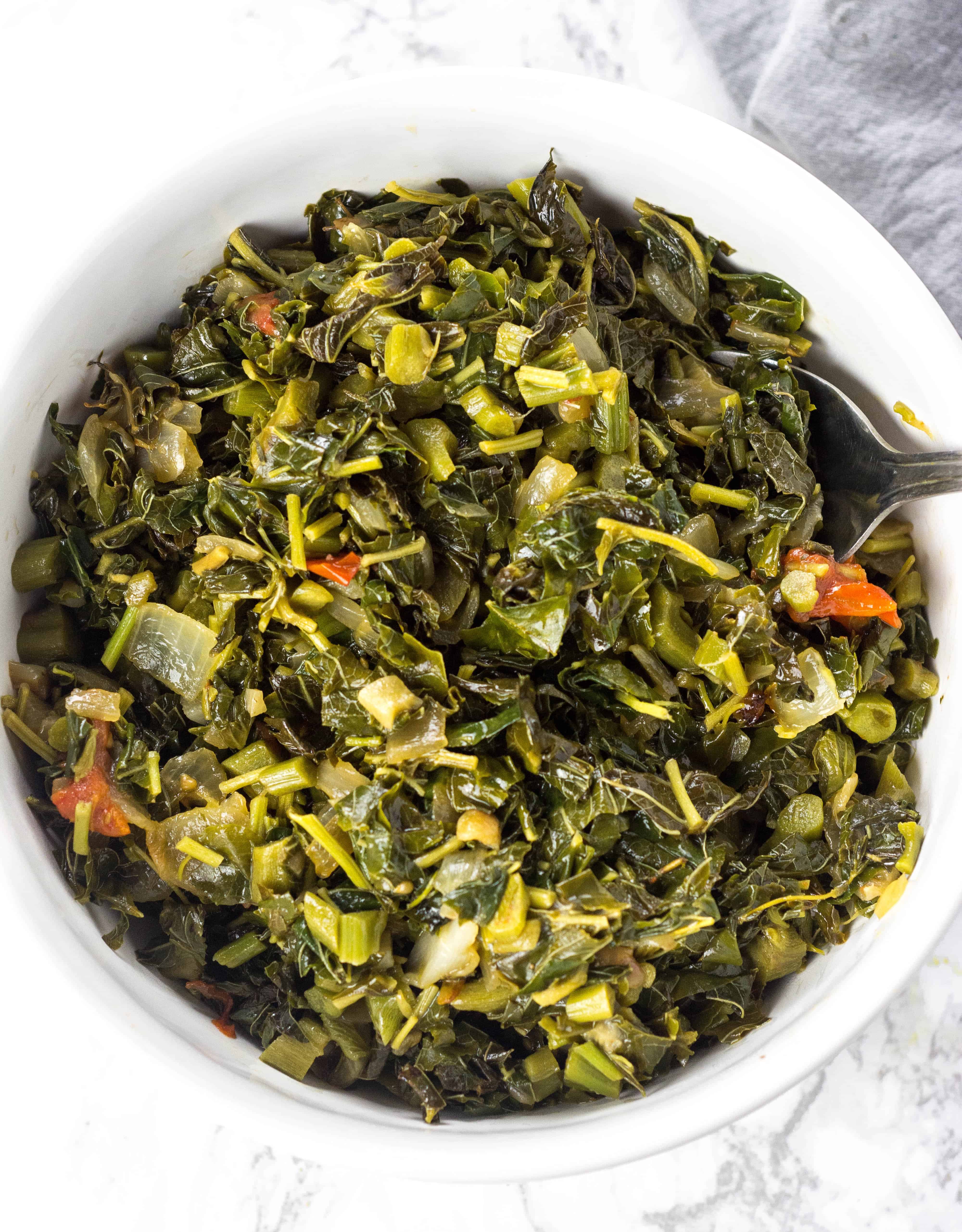 Overhead photo of cooked Jamaican Callaloo in a white bowl