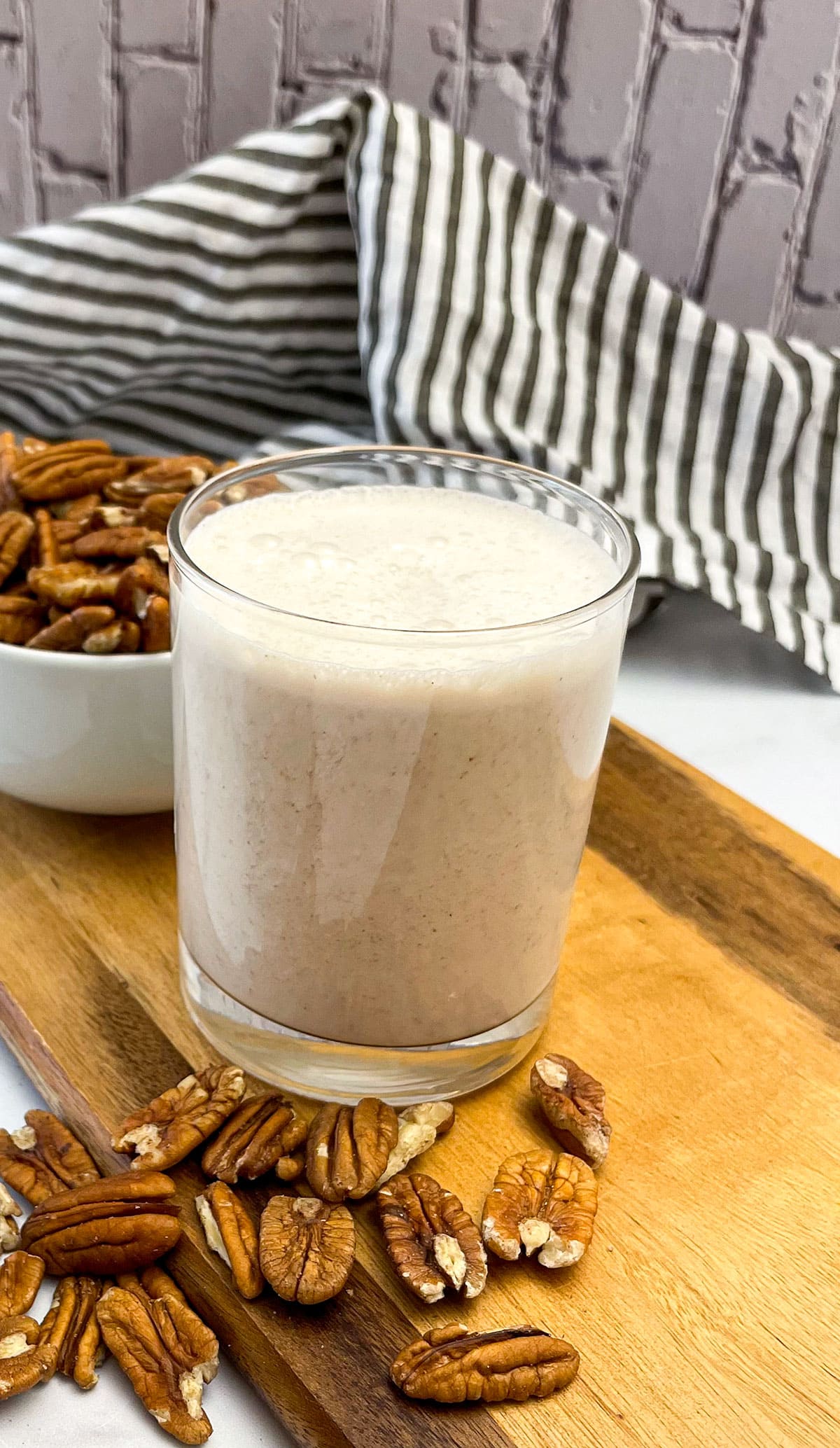 pecan milk in glass jar on cutting board