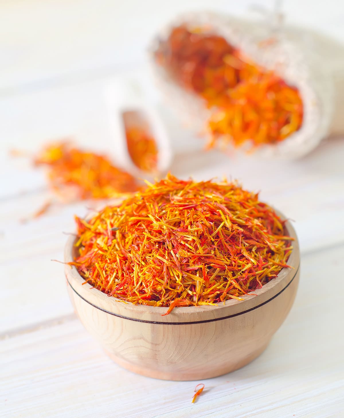 saffron threads in white bowl on white background