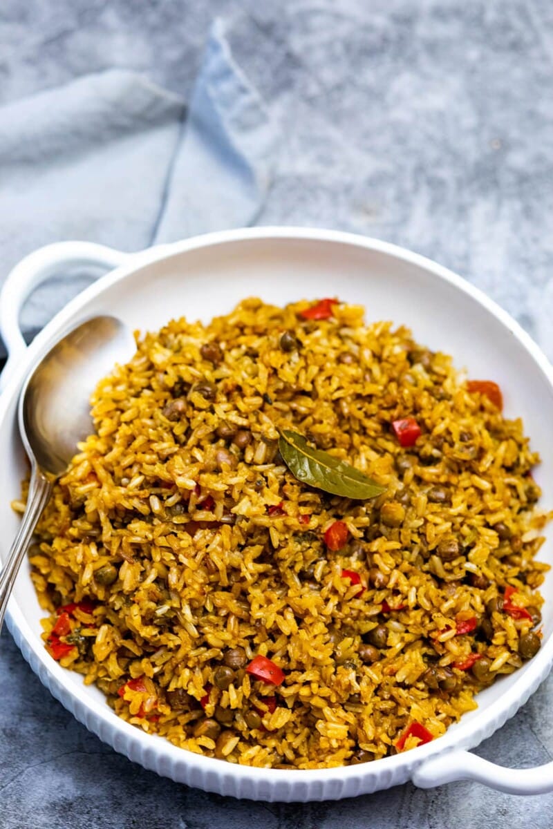 vegan trinidadian pelau recipe in a white bowl on a grey background