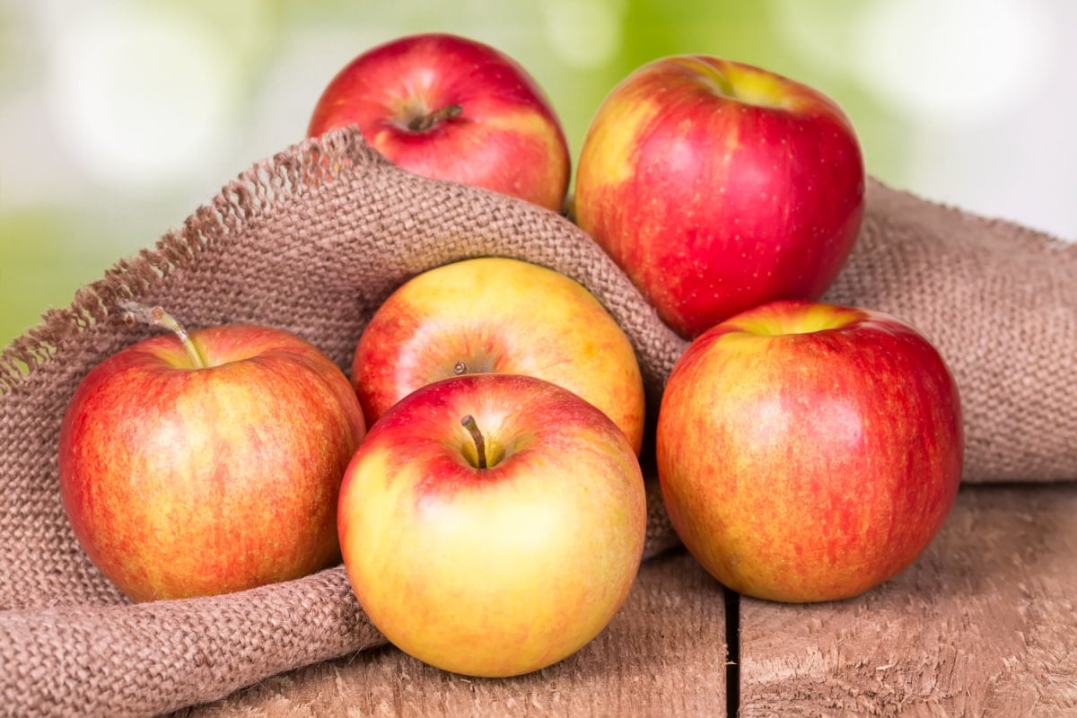 red apples on wooden surface