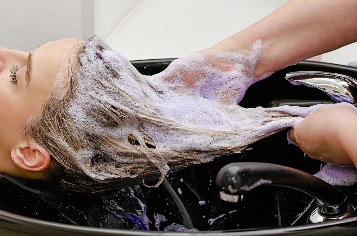 a lady getting her hair shampooed