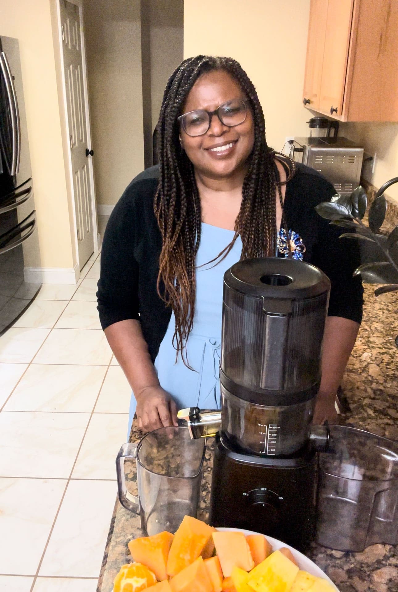 Michelle standing infront of her juicer about to make glowing skin juice