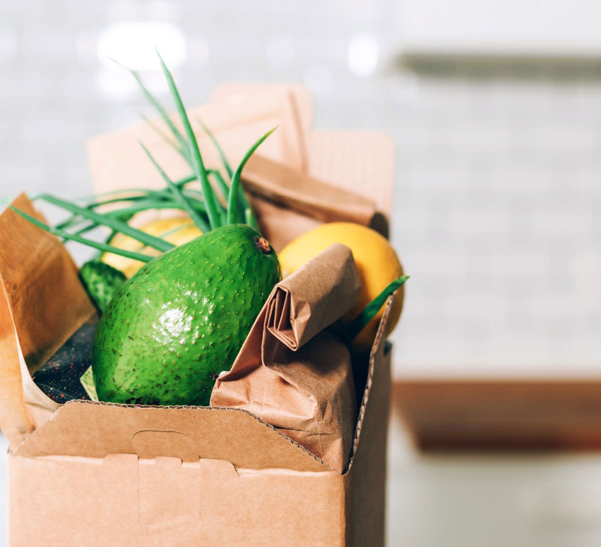 A CSA box on the counter with produce