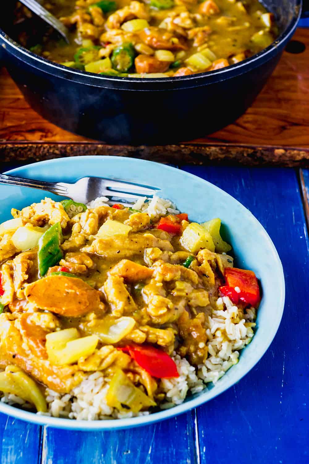 Vegan Gumbo in a blue bowl with rice on a blue background