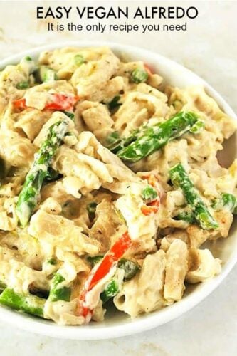 close-up image of vegan Alfredo pasta on a white plate