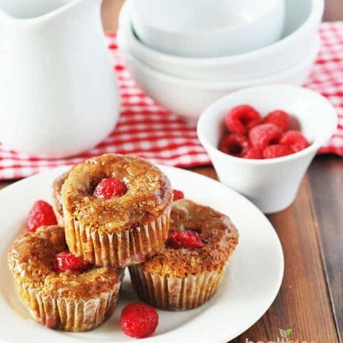 gluten free vegan raspberry muffins on white plate on wooden background