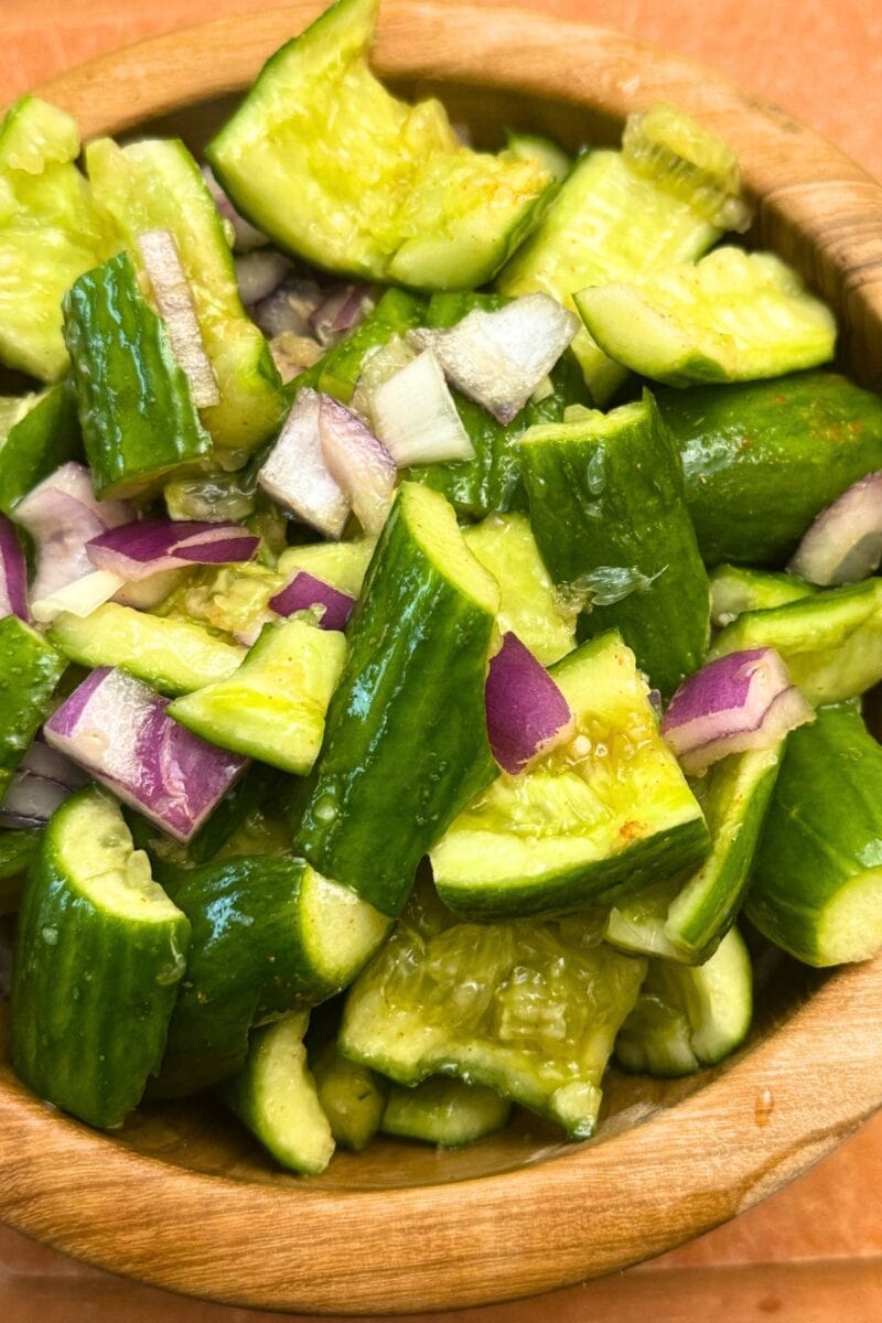 Smashed Cucumber Salad in a wooden bowl on a wooden background